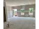 Spacious living room under construction with ample natural light and a door to the outdoor at 27 Benscot Dr, Austell, GA 30106