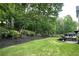 Beautiful backyard featuring a manicured lawn, privacy fence, mulch beds, and a deck perfect for outdoor entertaining at 310 Hillpine Dr, Woodstock, GA 30189
