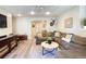 Finished basement with a comfortable seating area and an adjacent area for recreation at 310 Hillpine Dr, Woodstock, GA 30189