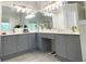 Bathroom featuring a double vanity with elegant lighting and large mirrors, providing ample space and light at 310 Hillpine Dr, Woodstock, GA 30189
