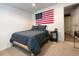 Cozy bedroom featuring neutral carpet, a comfortable bed, and an American flag adorning the wall at 310 Hillpine Dr, Woodstock, GA 30189