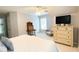 Bedroom featuring a dresser, a bedside table and TV with a ceiling fan at 310 Hillpine Dr, Woodstock, GA 30189