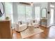 Bright breakfast nook is decorated with light colors and features a view out the many windows at 310 Hillpine Dr, Woodstock, GA 30189
