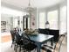 Inviting dining area featuring a blue table, stylish black chairs, and a decorative lantern-style chandelier at 310 Hillpine Dr, Woodstock, GA 30189