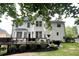 Exterior view of a two-story house highlighting the deck, well-maintained lawn, and manicured landscaping at 310 Hillpine Dr, Woodstock, GA 30189