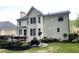 Rear exterior view highlighting the deck area, well-manicured lawn, and the classic architecture of the house at 310 Hillpine Dr, Woodstock, GA 30189