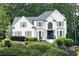 Charming white brick home with a manicured lawn and dark shutters, adding to the curb appeal at 310 Hillpine Dr, Woodstock, GA 30189