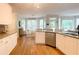 Bright kitchen featuring white cabinets, granite countertops, stainless steel appliances, and hardwood floors at 310 Hillpine Dr, Woodstock, GA 30189