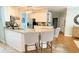 Kitchen features a granite countertop island with barstool seating and modern appliances at 310 Hillpine Dr, Woodstock, GA 30189