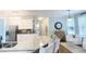 Bright kitchen featuring white cabinetry, granite counters, stainless appliances and hardwood floors at 310 Hillpine Dr, Woodstock, GA 30189