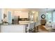 Well-lit kitchen with granite countertops, stainless steel appliances, and a view to the living area at 310 Hillpine Dr, Woodstock, GA 30189