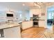 Open kitchen flows into the living room, featuring granite countertops and modern appliances at 310 Hillpine Dr, Woodstock, GA 30189