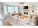 Cozy living room with fireplace, mounted TV, hardwood floors, and lots of natural light at 310 Hillpine Dr, Woodstock, GA 30189