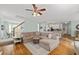 Open living room and kitchen featuring a sectional sofa and staircase at 310 Hillpine Dr, Woodstock, GA 30189