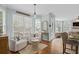 Bright living space with open floor plan, seamlessly connecting the kitchen to cozy seating and outdoor views for relaxed living at 310 Hillpine Dr, Woodstock, GA 30189