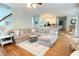 Spacious living room featuring a comfortable sectional sofa and seamless flow to the kitchen, ideal for modern living at 310 Hillpine Dr, Woodstock, GA 30189