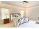 Spacious main bedroom features a tray ceiling, soft natural light and neutral color scheme at 310 Hillpine Dr, Woodstock, GA 30189