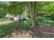 Charming backyard with a shaded swing set, complemented by blossoming plants and a verdant lawn at 3870 Michaels Creek Ct, Loganville, GA 30052