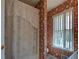 Bathroom with floral wallpaper, decorative lace shower curtain, and large window at 3870 Michaels Creek Ct, Loganville, GA 30052