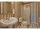 Bathroom with patterned wallpaper, vanity sink, and stand up shower at 3870 Michaels Creek Ct, Loganville, GA 30052