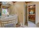Charming bathroom with double sinks, ornate mirrors, and access to the Primary bedroom at 3870 Michaels Creek Ct, Loganville, GA 30052