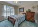 Bright bedroom with a large window, comfortable bed, and dresser for ample storage at 3870 Michaels Creek Ct, Loganville, GA 30052
