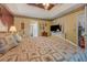 Spacious bedroom with a decorative ceiling, a large bed, and access to the bath and closet at 3870 Michaels Creek Ct, Loganville, GA 30052