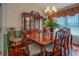 Formal dining room featuring a large wooden table, elegant chandelier, and wainscoting at 3870 Michaels Creek Ct, Loganville, GA 30052