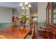 Spacious dining room with a large wood table, elegant chandelier, and ample natural light at 3870 Michaels Creek Ct, Loganville, GA 30052