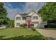 Charming two-story home with a well-manicured lawn and a pop of color from the red front door at 3870 Michaels Creek Ct, Loganville, GA 30052