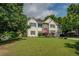 Charming two-story home with a well-manicured lawn and a pop of color from the red front door at 3870 Michaels Creek Ct, Loganville, GA 30052