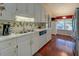 Bright kitchen with white cabinets, wood floors, and a double sink at 3870 Michaels Creek Ct, Loganville, GA 30052