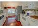 Bright kitchen with white cabinets, stainless steel appliances, and hardwood floors at 3870 Michaels Creek Ct, Loganville, GA 30052