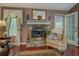 Living room showcasing a stone fireplace with mantel, hardwood floors, and neutral decor at 3870 Michaels Creek Ct, Loganville, GA 30052