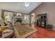 Cozy living room features a stone fireplace, hardwood floors, and access to the outdoors at 3870 Michaels Creek Ct, Loganville, GA 30052