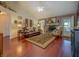 Cozy living room featuring hardwood floors, a stone fireplace, and comfortable seating at 3870 Michaels Creek Ct, Loganville, GA 30052
