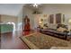 Spacious living room with hardwood floors, vaulted ceilings, and comfortable leather sofa at 3870 Michaels Creek Ct, Loganville, GA 30052