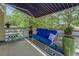 Relaxing porch with awning, comfortable seating, and decorative pillows perfect for outdoor enjoyment at 3870 Michaels Creek Ct, Loganville, GA 30052