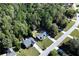 Picturesque aerial view showcasing a neighborhood with well-maintained homes surrounded by dense, mature trees at 540 Windermere Dr, Loganville, GA 30052