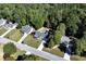 Picturesque aerial view showcasing a neighborhood with well-maintained homes surrounded by dense, mature trees at 540 Windermere Dr, Loganville, GA 30052