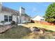 Spacious backyard featuring a patio, fire pit, and well-maintained lawn under the pergola at 540 Windermere Dr, Loganville, GA 30052