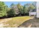 Large backyard with a playset, fire pit, and covered patio area, perfect for gatherings at 540 Windermere Dr, Loganville, GA 30052