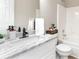 Bathroom featuring white vanity with granite countertops, modern faucet, and a combined bathtub and shower at 540 Windermere Dr, Loganville, GA 30052