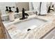 Bathroom vanity featuring a granite countertop, modern faucet, and stylish soap dispensers at 540 Windermere Dr, Loganville, GA 30052