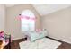 Bright bedroom with a large arched window, plush carpeting, and whimsical decor at 540 Windermere Dr, Loganville, GA 30052