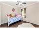 Charming bedroom with hardwood floors, bright windows, and a comfortable bed with a decorative headboard at 540 Windermere Dr, Loganville, GA 30052