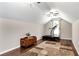 Finished bonus room with a ceiling fan, natural light, and hardwood floors, suitable for exercise equipment at 540 Windermere Dr, Loganville, GA 30052