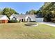 Charming single-story home with a well-manicured lawn and inviting curb appeal on a sunny day at 540 Windermere Dr, Loganville, GA 30052