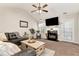 Inviting living room with a cozy fireplace, vaulted ceilings, and seamless flow to dining area at 540 Windermere Dr, Loganville, GA 30052