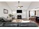 Inviting living room with a cozy fireplace, vaulted ceilings, and seamless flow to dining area at 540 Windermere Dr, Loganville, GA 30052